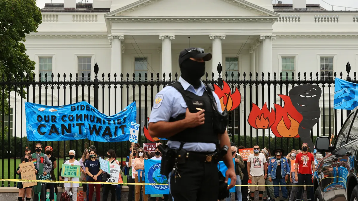 Demonstrators prepare to be arrested during a rally outside the White House as part of the 'Climate Chaos Is Happening Now' protest on October 13, 2021 in Washington, DC