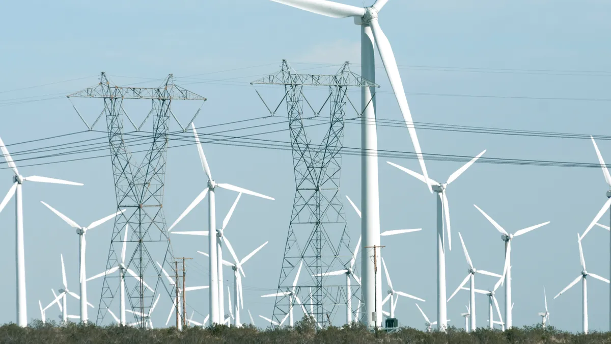 Wind farm and electricity pylons in the desert of Coachella Valley, California.